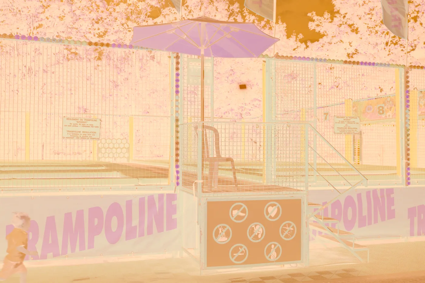 The raw scan of the trampoline: the orange banner reads blue, the trees a pale pink, under the orange base.